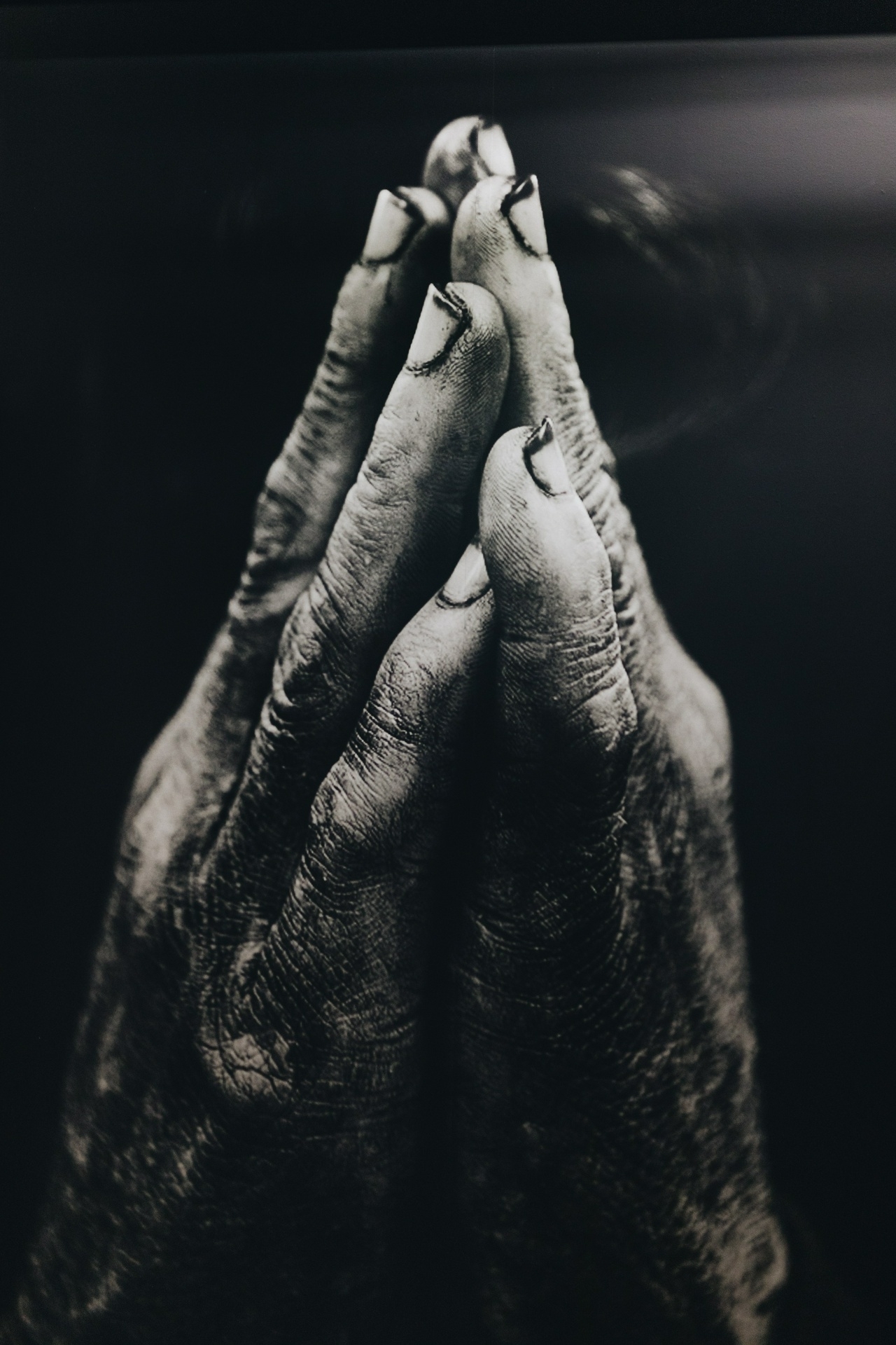 Photo of dirty hands clasped in prayer by Nathan Dumlao on Unsplash