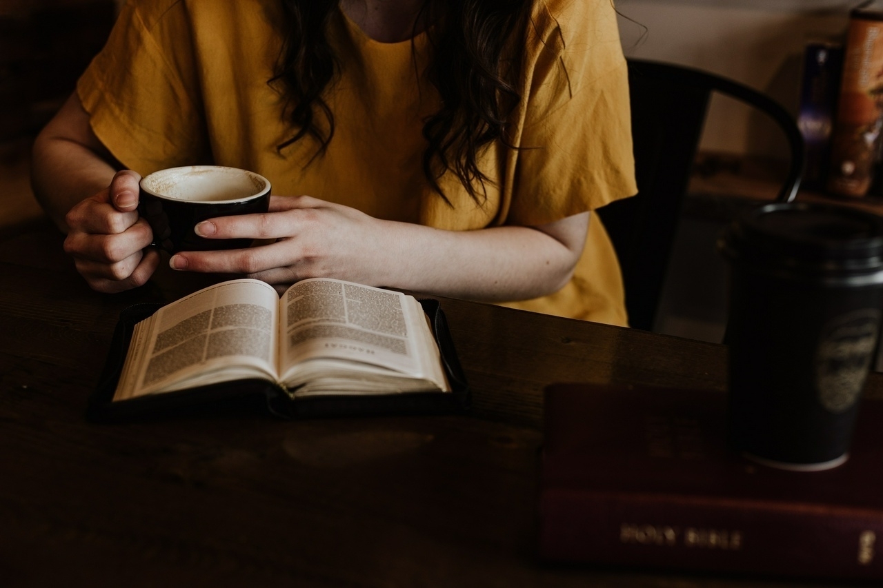 Photo of a woman reading the Bible holding a cup of coffee by Priscilla Du Preez 🇨🇦 on Unsplash 